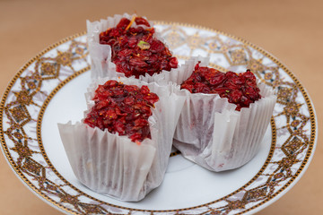 Three slices of fruit barberry lokum on a saucer, a traditional