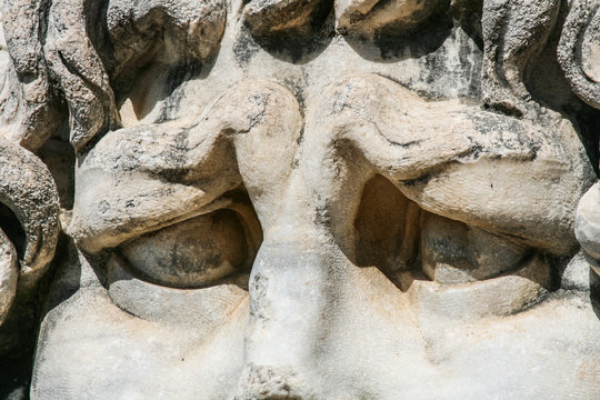 severe look  of the ancient Roman deity in the temple of Apollo, the ancient town of Didim