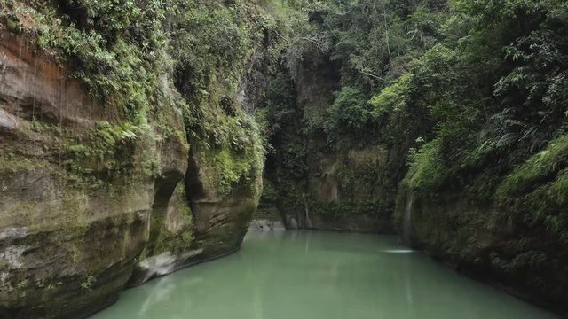 Guejar Canyon, in Mesetas Colombia, crystal clear waters, emerald green waters, low-altitude overflight, with large stones. Aerial drone video.