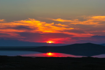 Fototapeta na wymiar Incredible sunset on the lake Opuk, on the Black Sea, Crimea