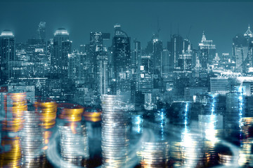 Business financial ideas concept with money coin stack and city building background.