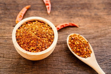 chili pepper powder in bowl on wooden table