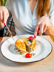 Obraz na płótnie Canvas woman eating potato pancake with meat