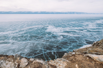 Russia. Lake Baikal. March. Panorama in blue tones ice-covered lake and mountains