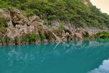 Amazing crystalline blue water of Tamul waterfall, Close up view of spectacular Tamul River,at Huasteca Potosina in San Luis Potosi, Mexico