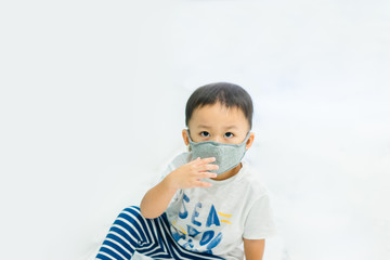 Coronavirus and Air pollution pm2.5 concept.Little chinese wuhan boy wearing mask for protect pm2.5 in Airport terminal.Toddler boy play in airport.Wuhan coronavirus and epidemic virus symptoms.