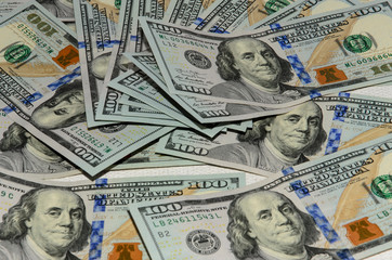 One hundred dollars pile as background.