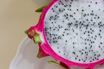 Exotic fruit, half dragon fruit or pitaya on a light background. space for text.