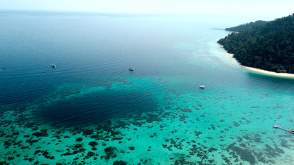 drone view of a dark blue hole in the ocean with beautiful coral reef in thailand