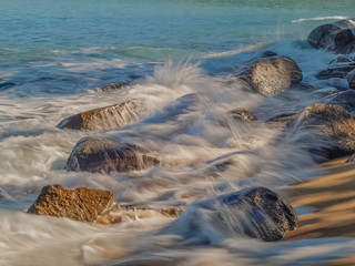 view seaside of wave attack many arch rocks with water splash and blue-green sea background, Khao Lak-Lam Ru National Park, Phang Nga, southern of Thailand.