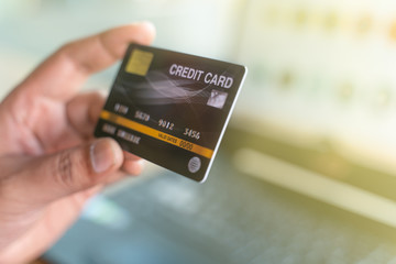 Man holding mock up credit card and laptop computer for online shopping.Online shopping, online payment,buy and sell products & services
