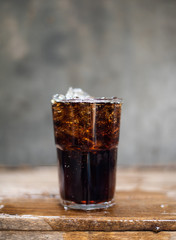 Cola in glass with ice cubes.