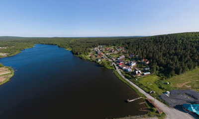 Aerial view of houses and pond in Pervouralsk city. Summer