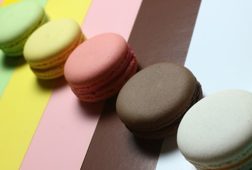 delicious French colored cakes on a multicolored background
