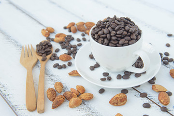Cup of coffee with grains on wooden background