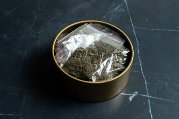 drug trade: many packaged doses of cannabis lie in a metal can