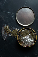 drug trade: many packaged doses of cannabis lie in a metal can