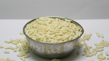 Puffed rice on the silver bowl with white background