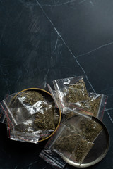 drug trade: a bag of hemp next to many packaged doses of cannabis lie in a metal can