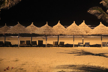  Night view of the beach with parasols and sunbath chairs in Danang, Vietnam