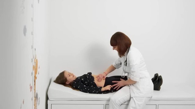 little girl undergoes abdominal examination in a private clinic
