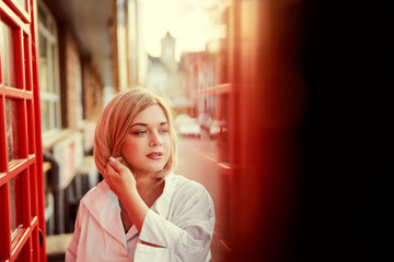 Fototapeta premium Outdoor portrait of happy young woman walking by city street.