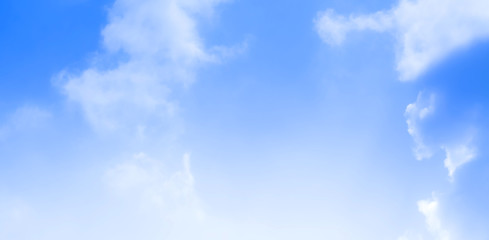 ิblue sky against white floating clouds background