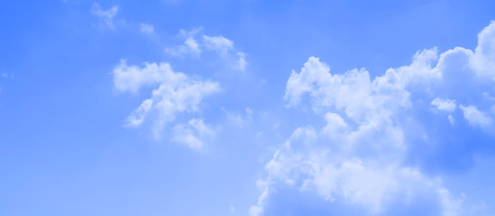 ิblue sky against white floating clouds background