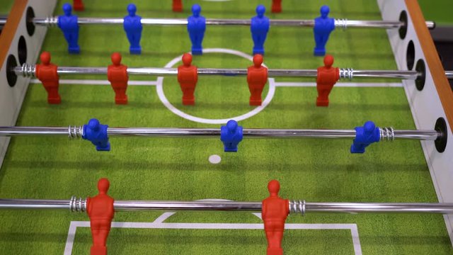 People playing foosball table soccer. Team sport, table football players. Competitive table game