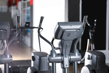 Elliptical trainer in gym. Modern sport equipment