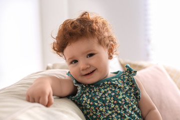 Portrait of cute little child on sofa at home