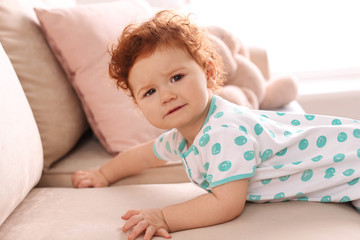 Portrait of cute little child on sofa at home