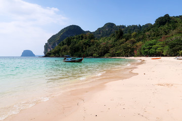 traditional longtailboat on a beach in thailand