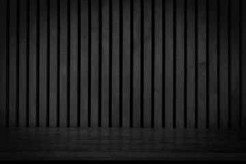 Black wooden board empty table in front of dark wood wall. Black wooden plank shelf on wood wall texture background.
