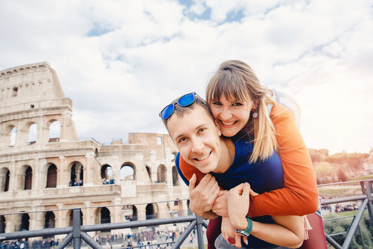 Travel couple man and girl taking selfie photo Colosseum landmark in Rome city. Concept europe Italy summer, people smiling