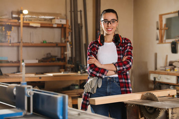 Professional carpenter near sawmill machine in workshop