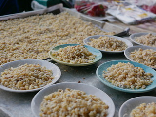 Selective focus of fresh red ant eggs for sale at a small local market in Thailand