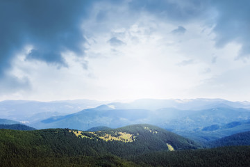 Obraz premium Picturesque mountain landscape with dark clouds and sunlight_