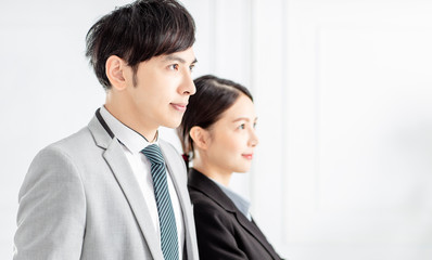 side view of Young smiling business woman and business man