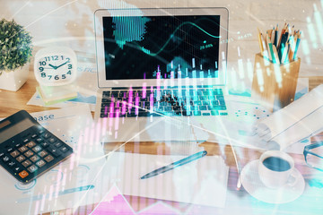 Forex market graph hologram and personal computer on background. Multi exposure. Concept of investment.