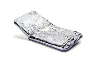 Mobile smartphone with broken screen on white background.