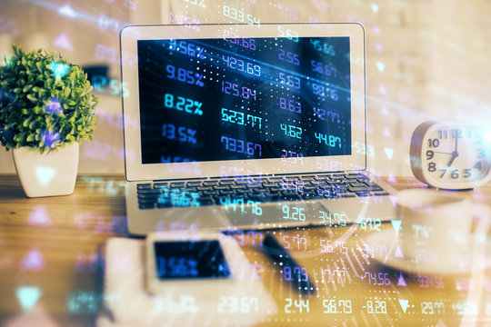 Financial graph colorful drawing and table with computer on background. Multi exposure. Concept of international markets.