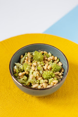 Bowl with yellow soy with cauliflower view from the top