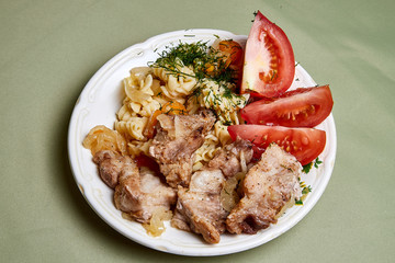Cooking. Grilled meat on a plate with garnish and tomatoes