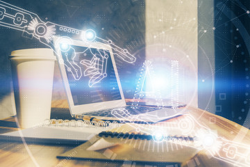 Double exposure of desktop computer and technology theme hologram. Concept of software development.