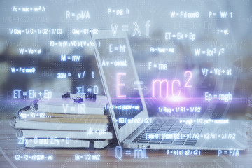 Desktop computer background and formula hologram writing. Double exposure. Education concept.