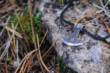 silver amulet hammer of Thor in the forest