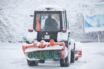 Utility equipment cleans the snow on the streets