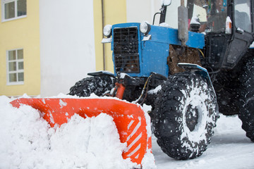 Utility equipment cleans the snow on the streets