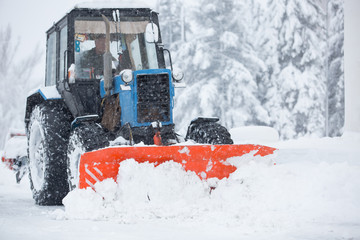Utility equipment cleans the snow on the streets
